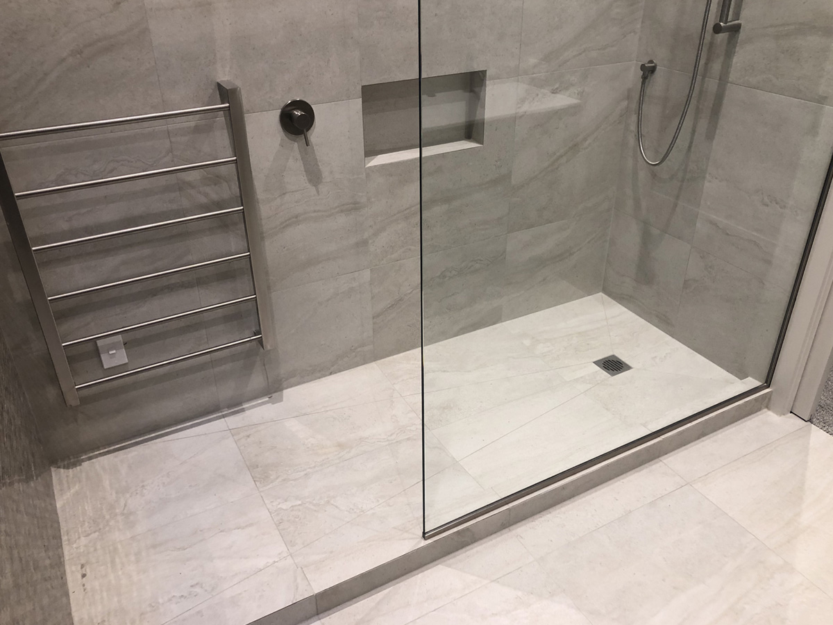 Tiled walk-in shower with linear drain in an Auckland bathroom